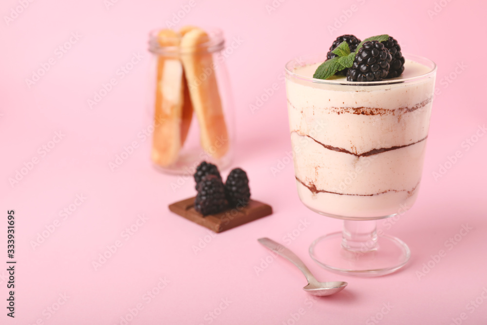 Tasty tiramisu with berries on color background