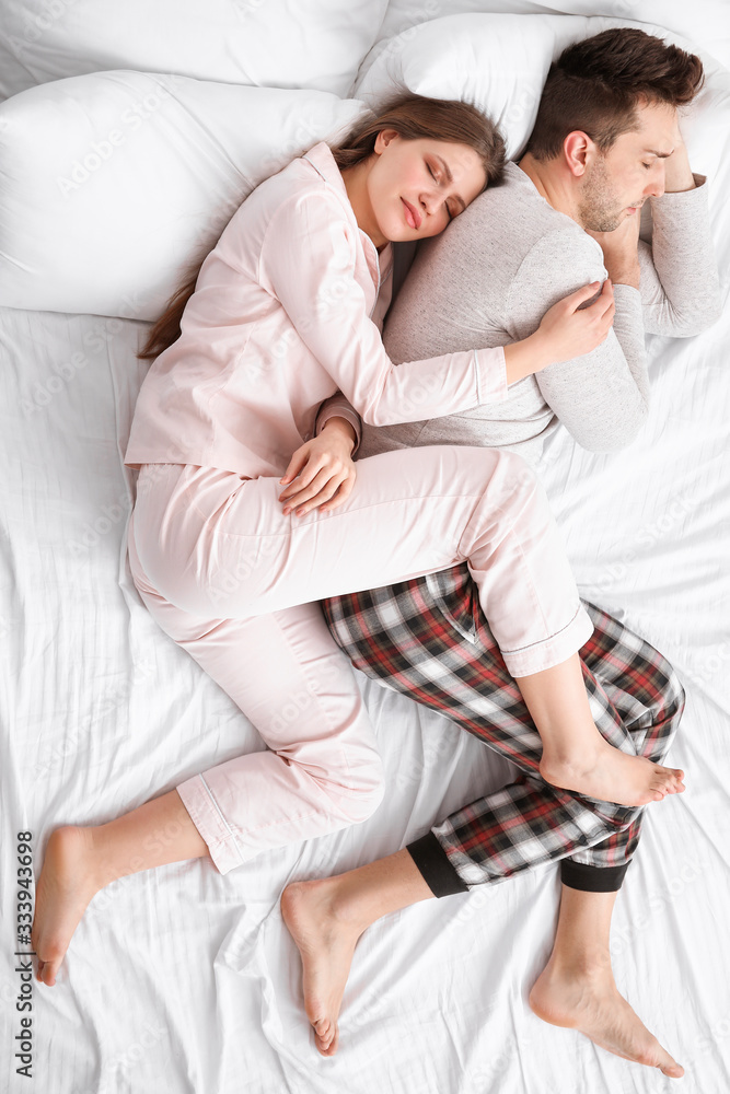 Young couple sleeping in bed