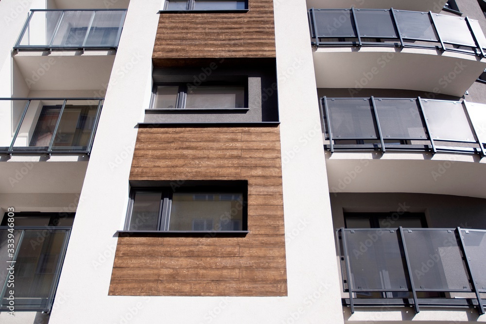 Urban lifestyle. Facade of new modern residential house. Apartment building in the city. 