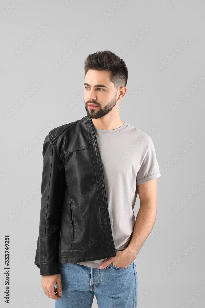 Handsome man with healthy hair on light background