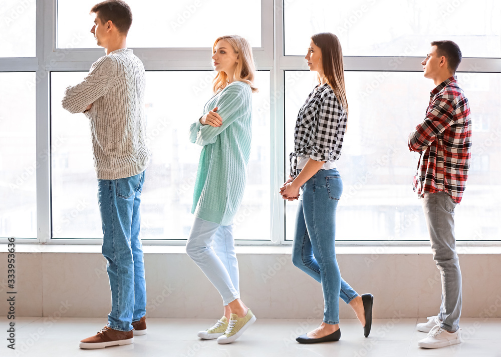 Young people in waiting line indoors