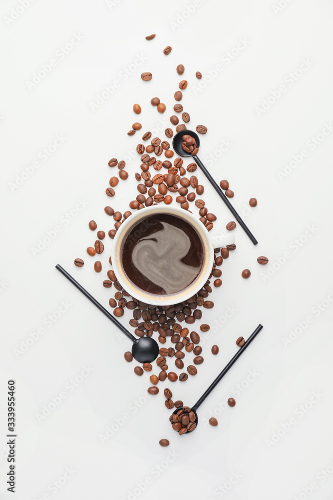 Cup of coffee with roasted beans on white background