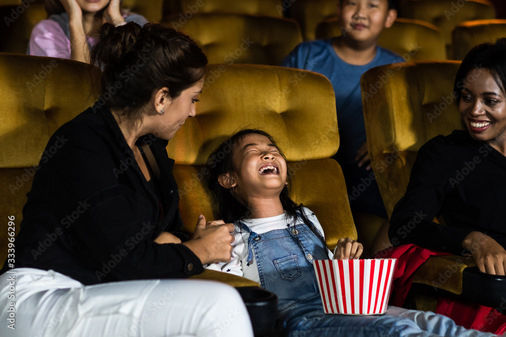 The girls cried loudly in the cinema, causing annoyance to the people sitting next to and behind the