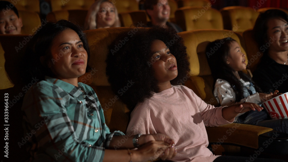 People audience watching movie in the movie theater cinema. Group recreation activity and entertainm