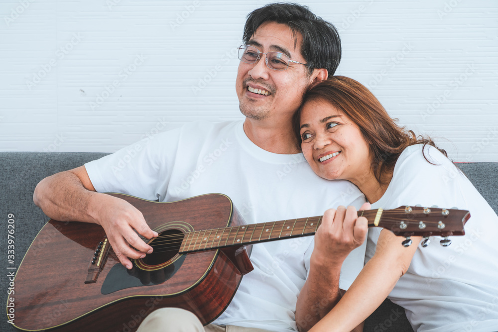 Happy Asian senior couple having good time at home. Old people retirement and healthy citizens elder