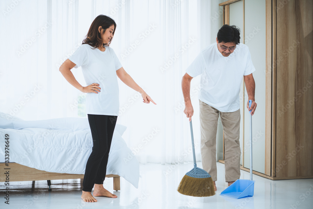 Asian senior couple cleaning bedroom floor. Retirement and healthy elderly concept.