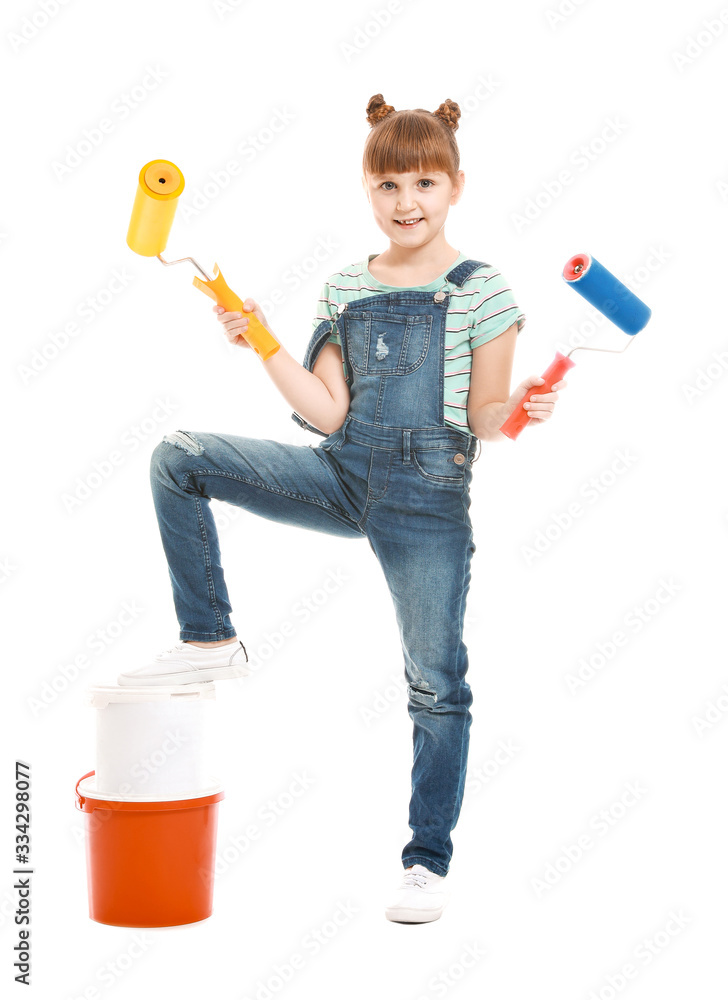 Little girl with paint rollers on white background