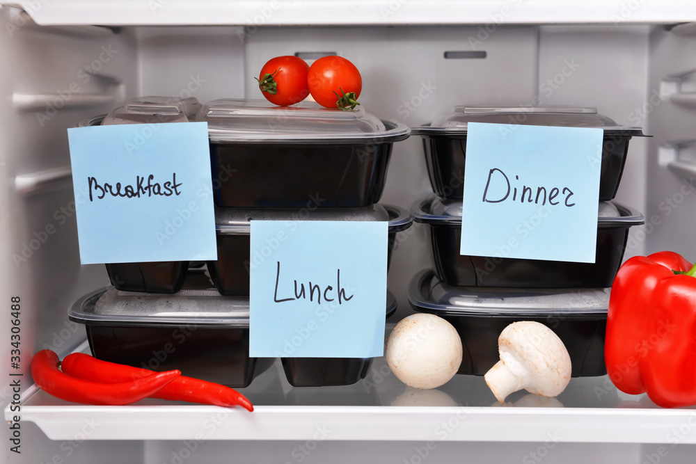 Containers with healthy food on shelf in fridge