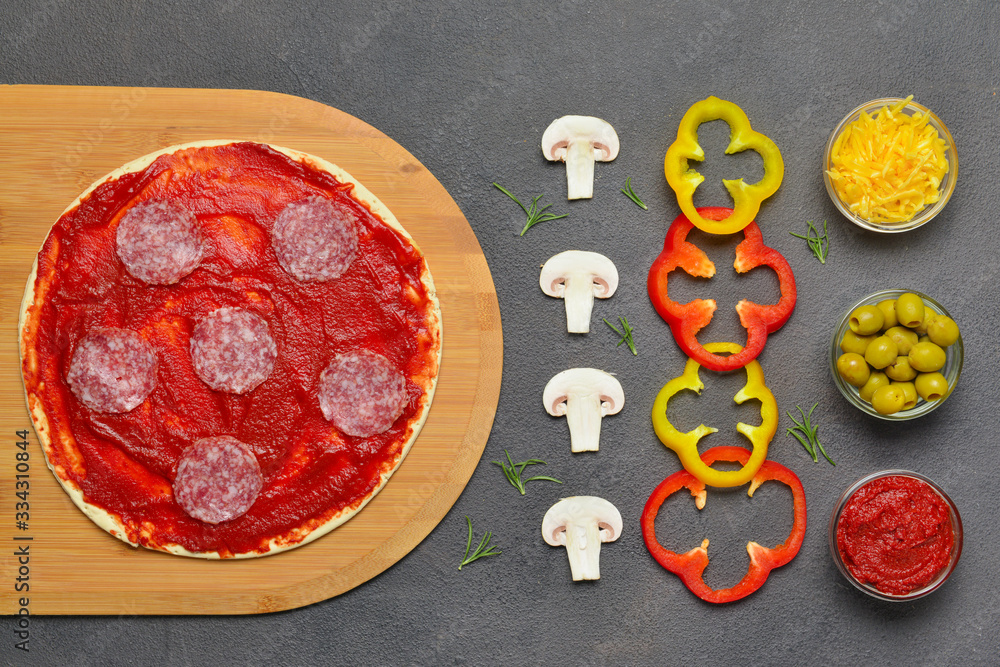 Ingredients for tasty pizza on dark background