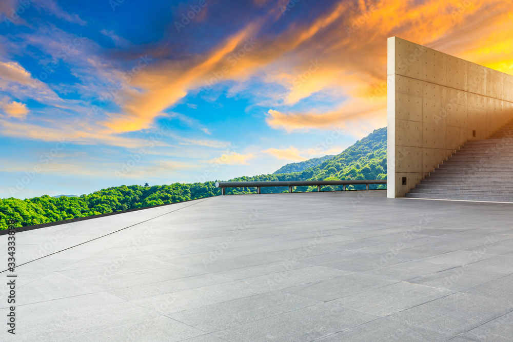 Empty square floor and green tea plantation nature landscape at sunset.