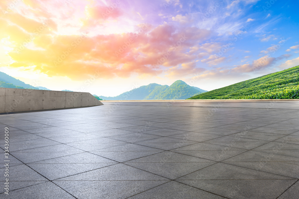 Empty square floor and green tea plantation nature landscape at sunset.