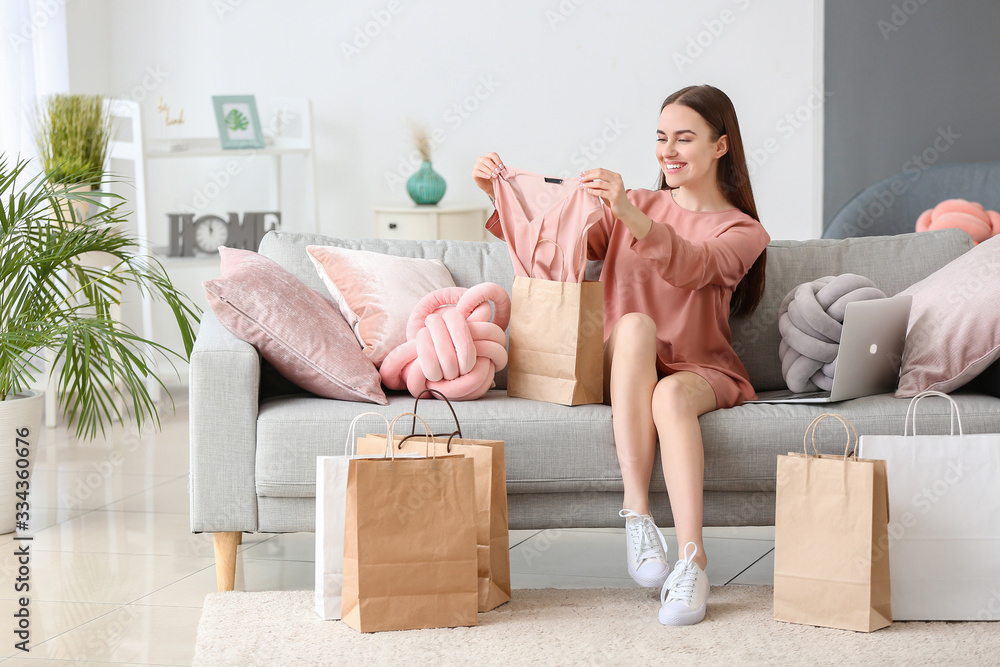 Young woman with shopping bags at home