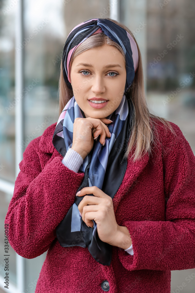 Beautiful young woman with stylish scarf outdoors