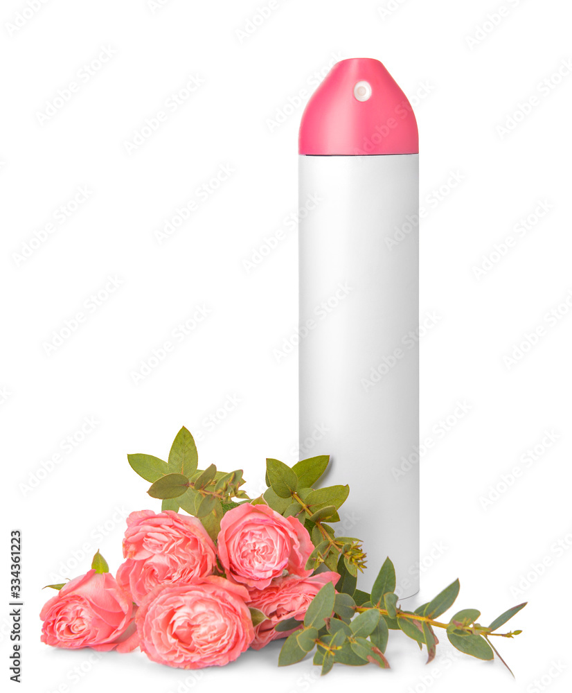 Bottle of air freshener and flowers on white background