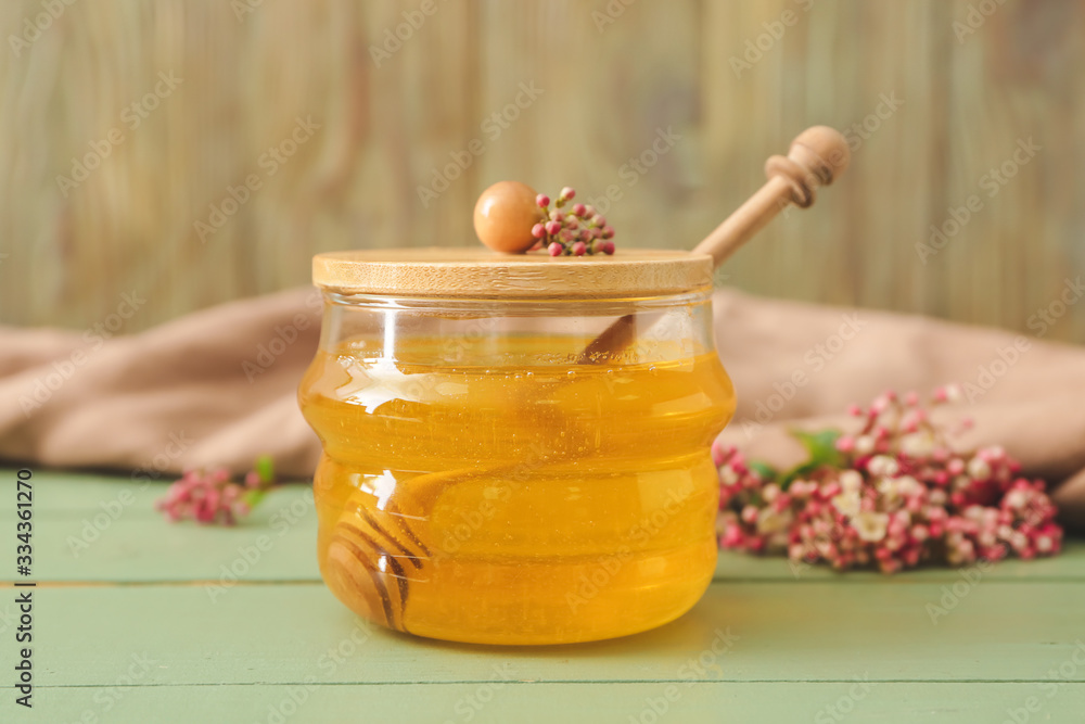 Jar of sweet honey on table