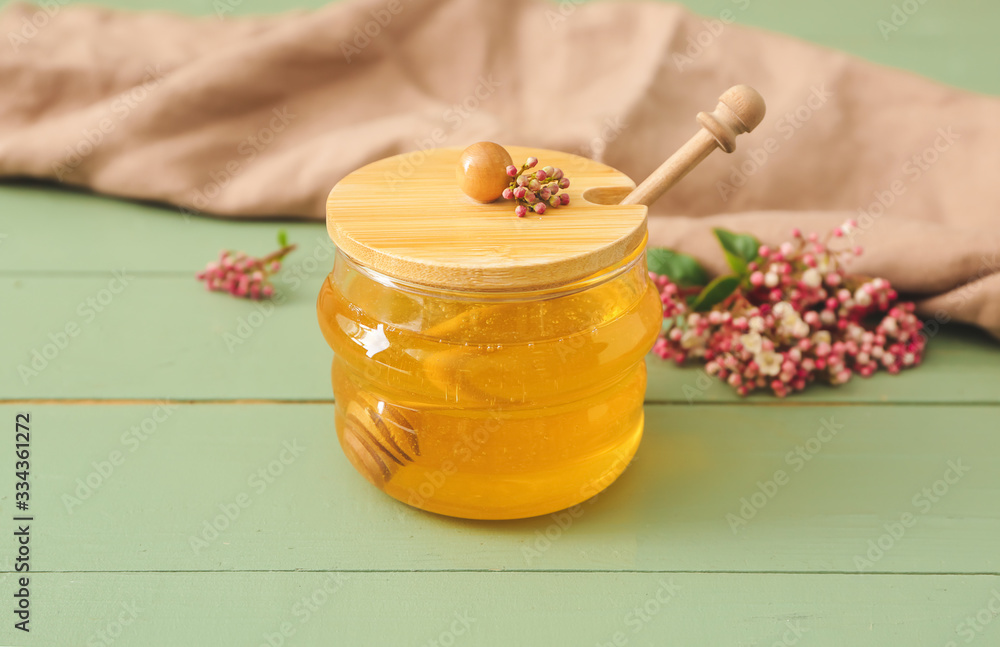 Jar of sweet honey on table