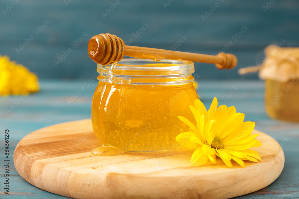 Jar of sweet honey on table