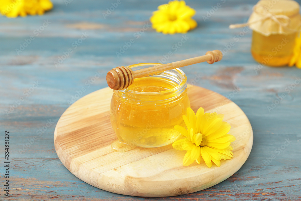 Jar of sweet honey on table