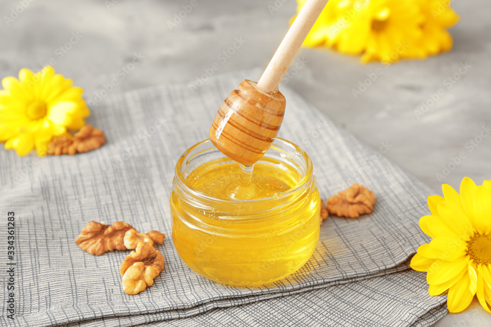 Jar of sweet honey on table