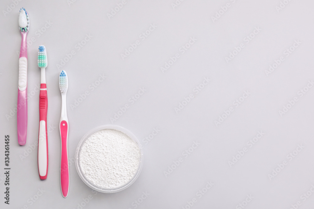 Tooth brushes with paste on light background