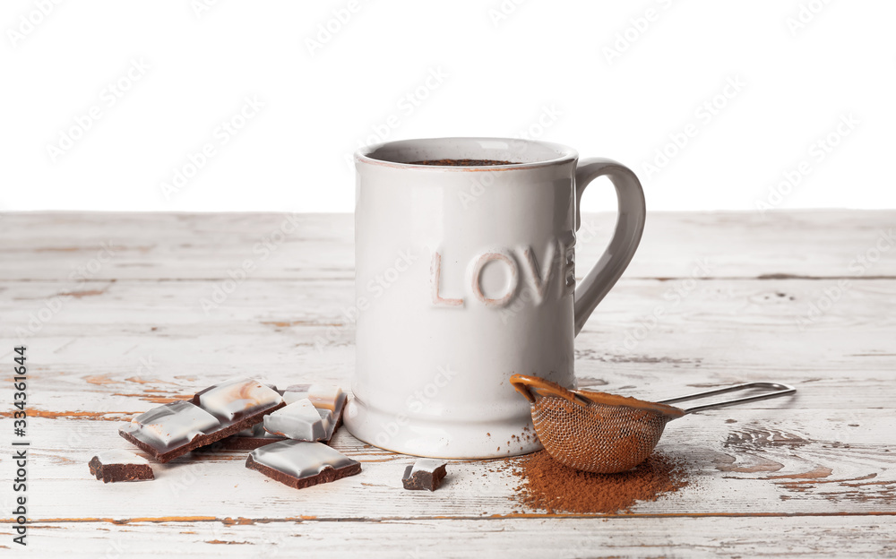 Cup of hot chocolate on table against white background