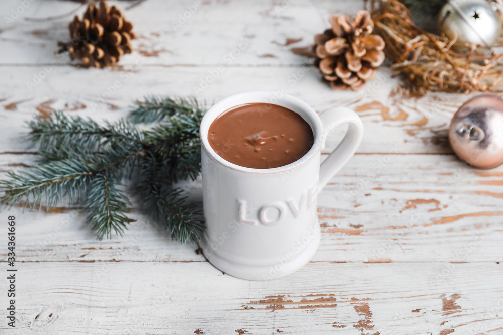 Cup of hot chocolate and Christmas decor on table