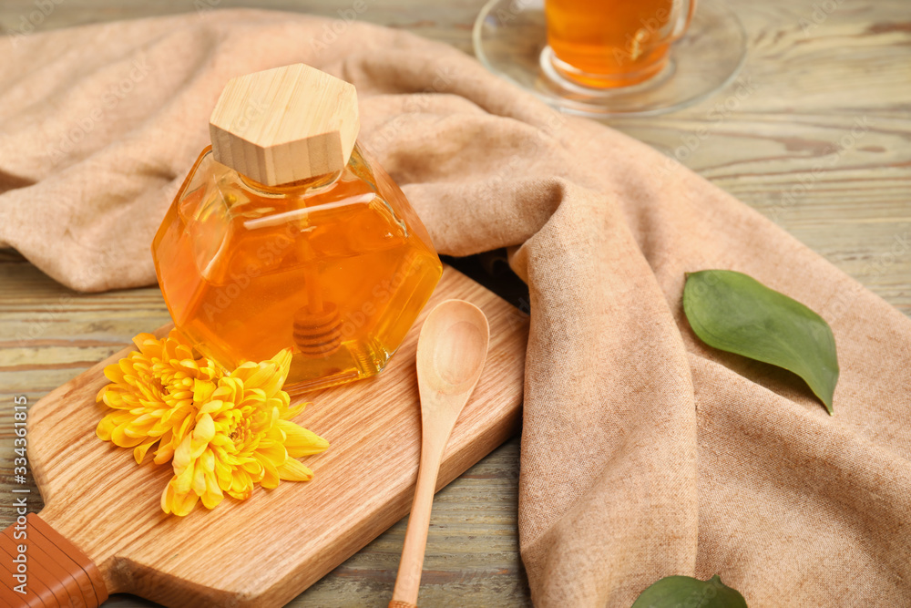 Jar of sweet honey on table