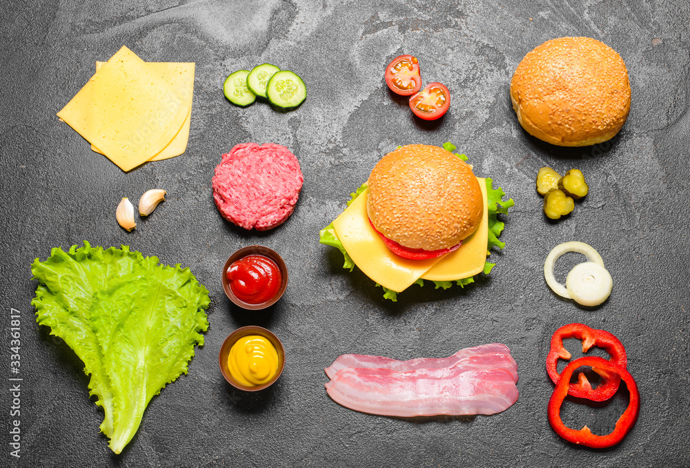 Ingredients for tasty burger on dark background