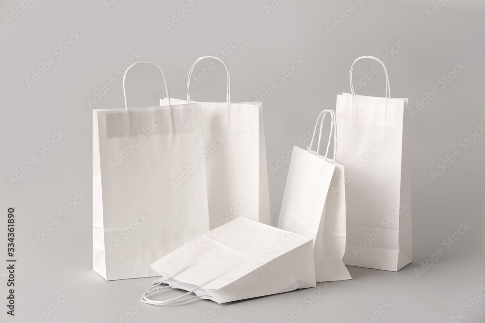 Paper shopping bags on light background