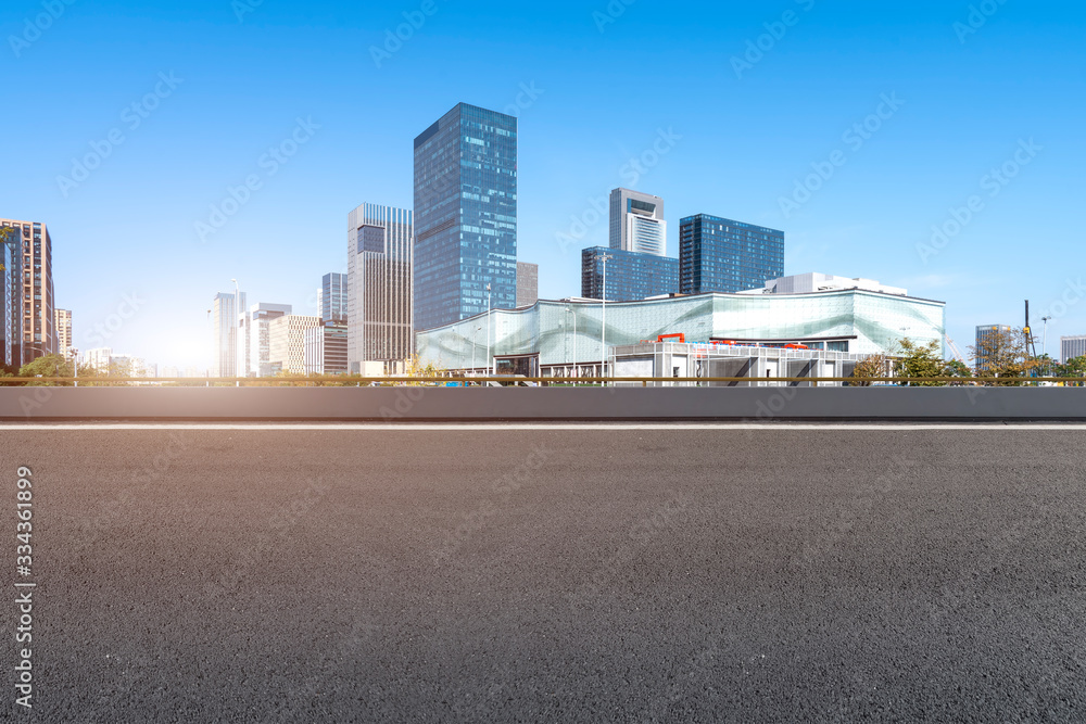 Asphalt road and Ningbo Financial District building office building..