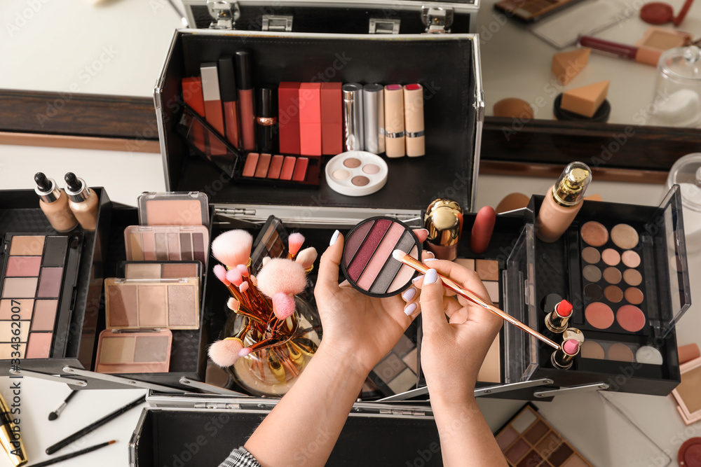 Makeup artist at workplace in beauty salon, top view