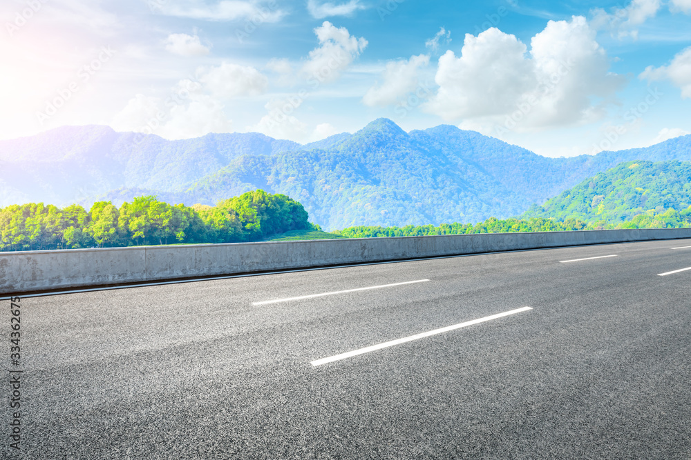 Empty asphalt road and green tea plantation nature landscape.