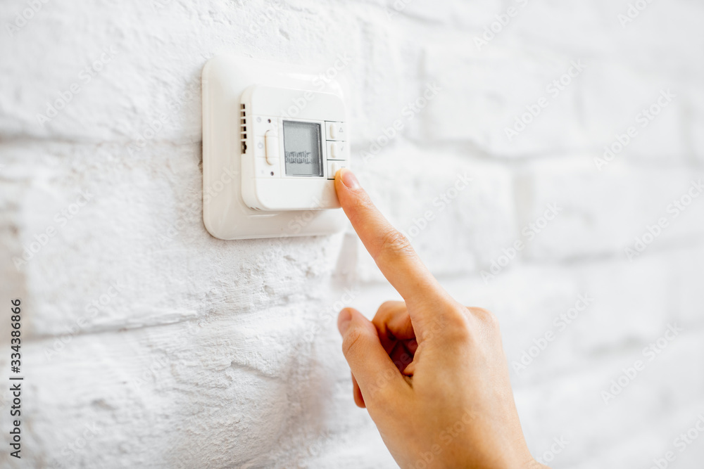 Setting temperature on the control panel of a floor heating, close-up