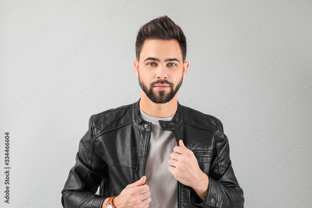 Handsome man with healthy hair on light background