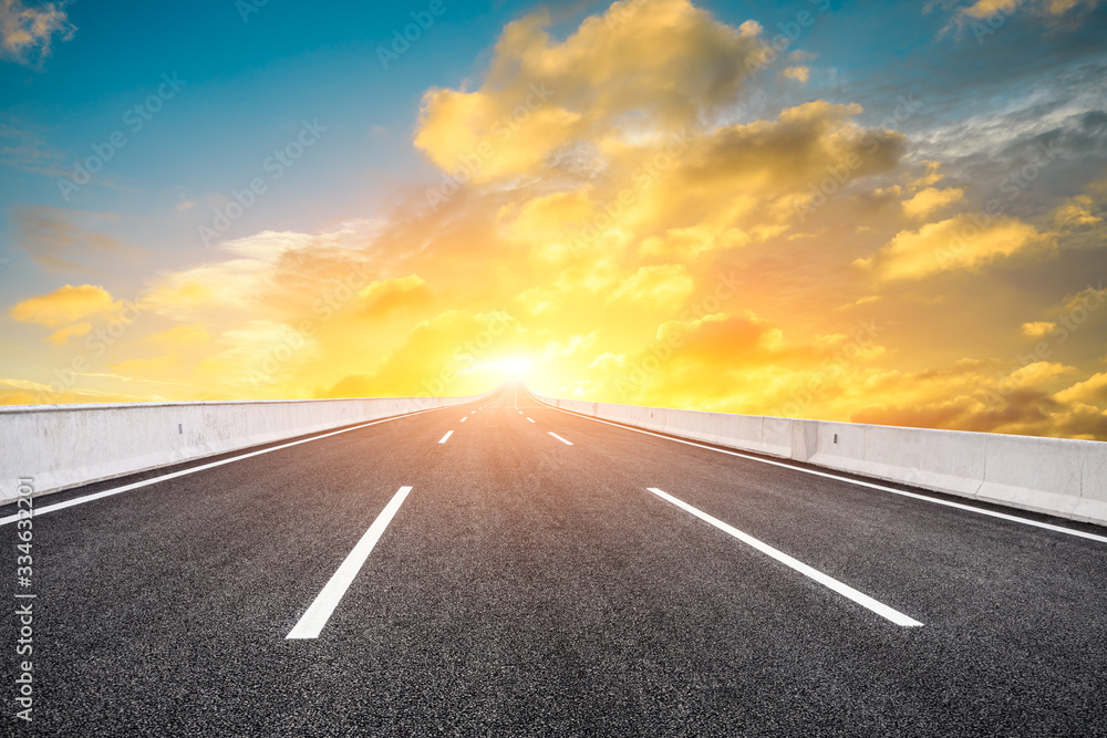 Asphalt highway road and sky sunset clouds landscape.