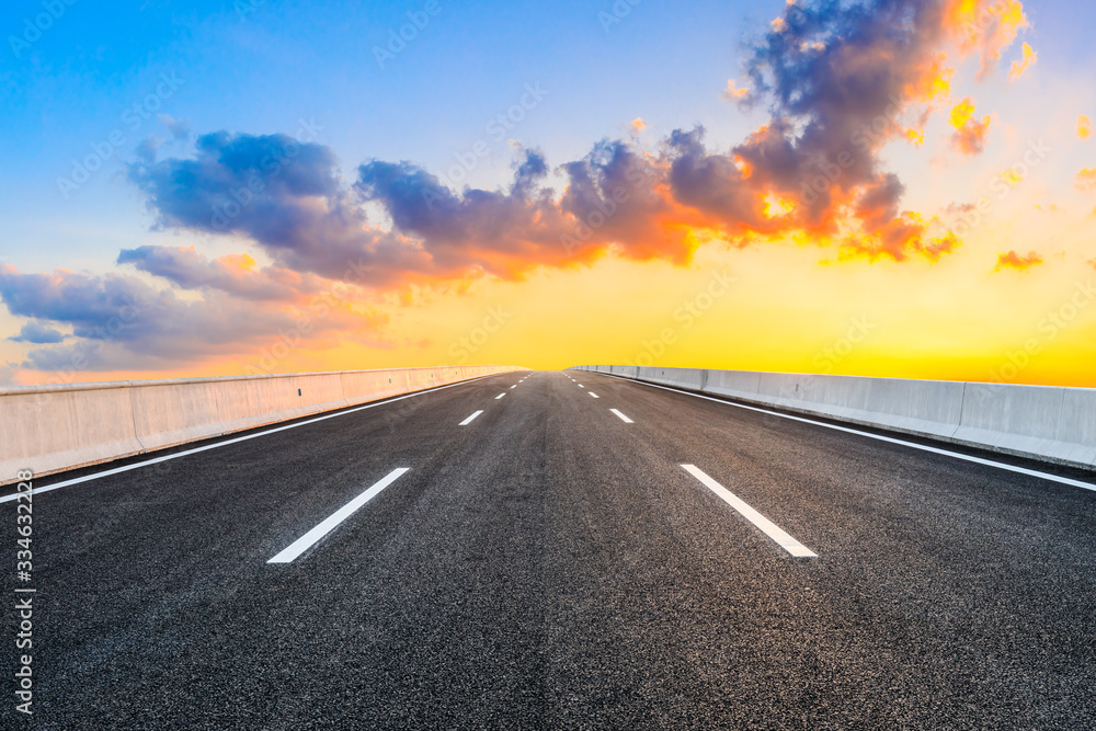 Asphalt highway road and sky sunset clouds landscape.