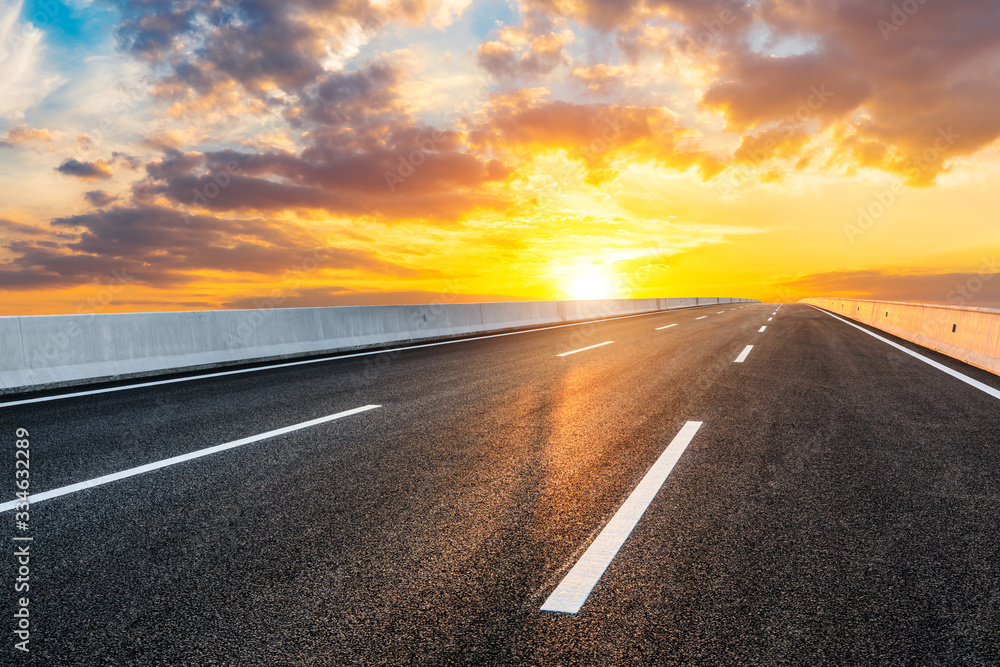 Asphalt highway road and sky sunset clouds landscape.