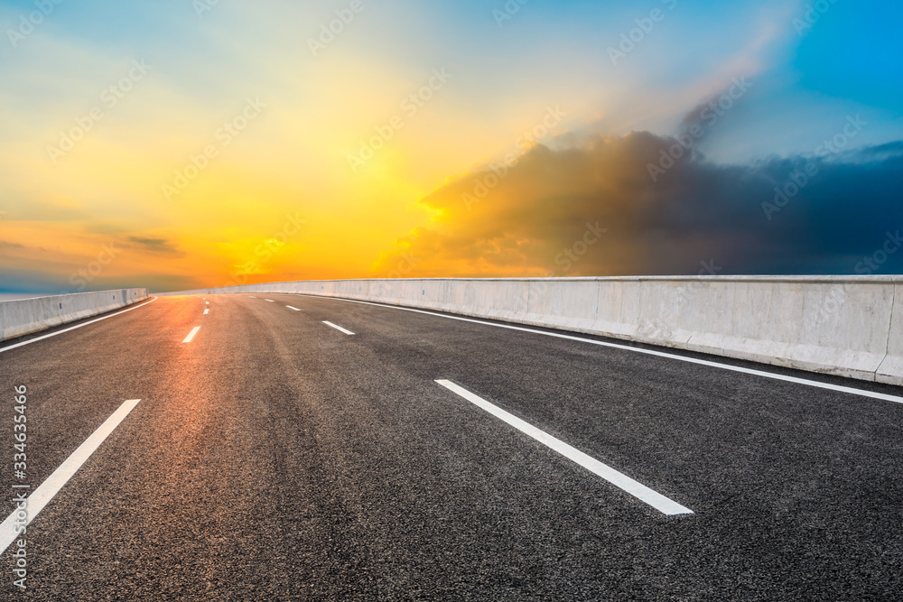 Asphalt highway road and sky sunset clouds landscape.