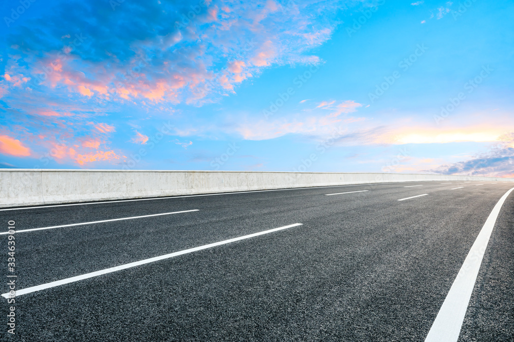 Asphalt highway road and sky sunset clouds landscape.