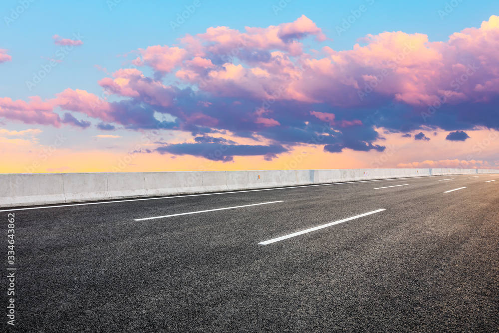 Asphalt highway road and sky sunset clouds landscape.