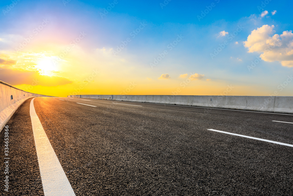 Asphalt highway road and sky sunset clouds landscape.