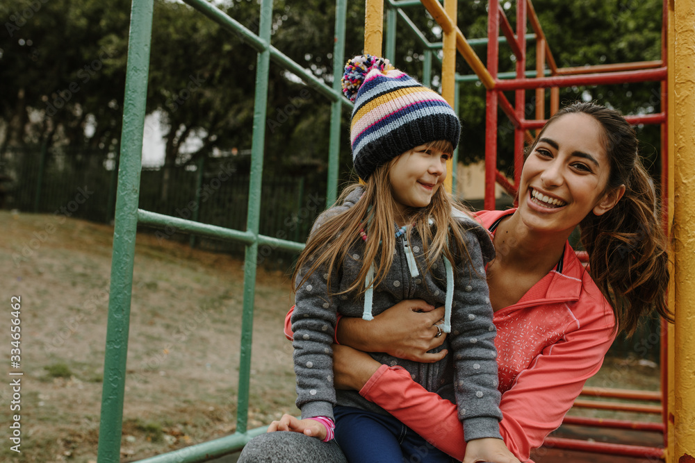 Babysitter with a girl at the park.