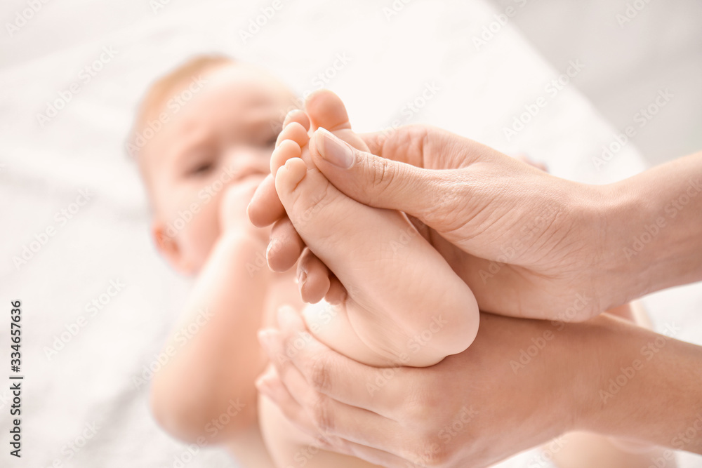 Massage therapist working with cute baby in medical center