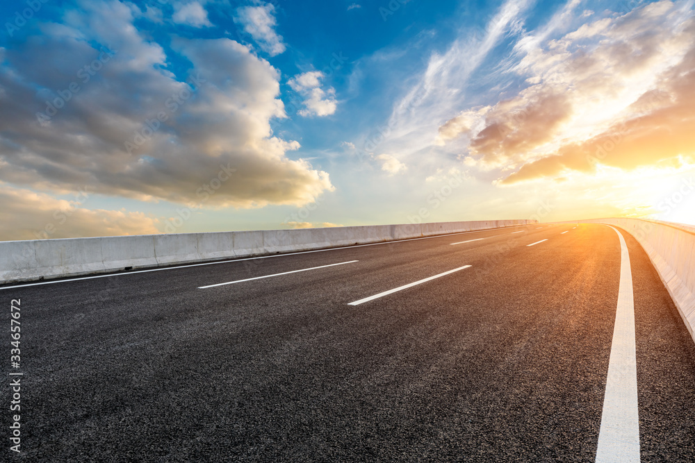 Asphalt highway road and sky sunset clouds landscape.