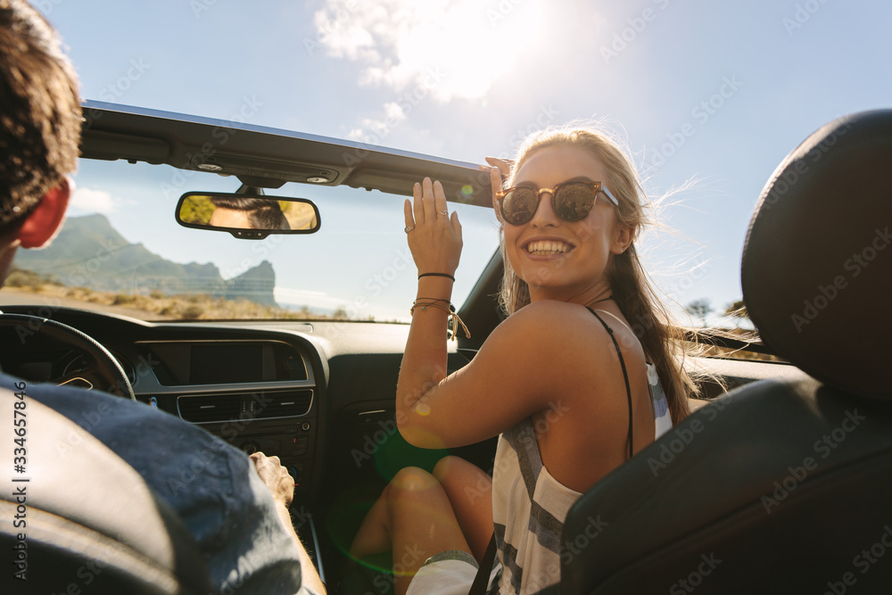 Woman traveling in a convertible car