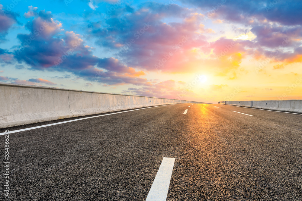 Asphalt highway road and sky sunset clouds landscape.