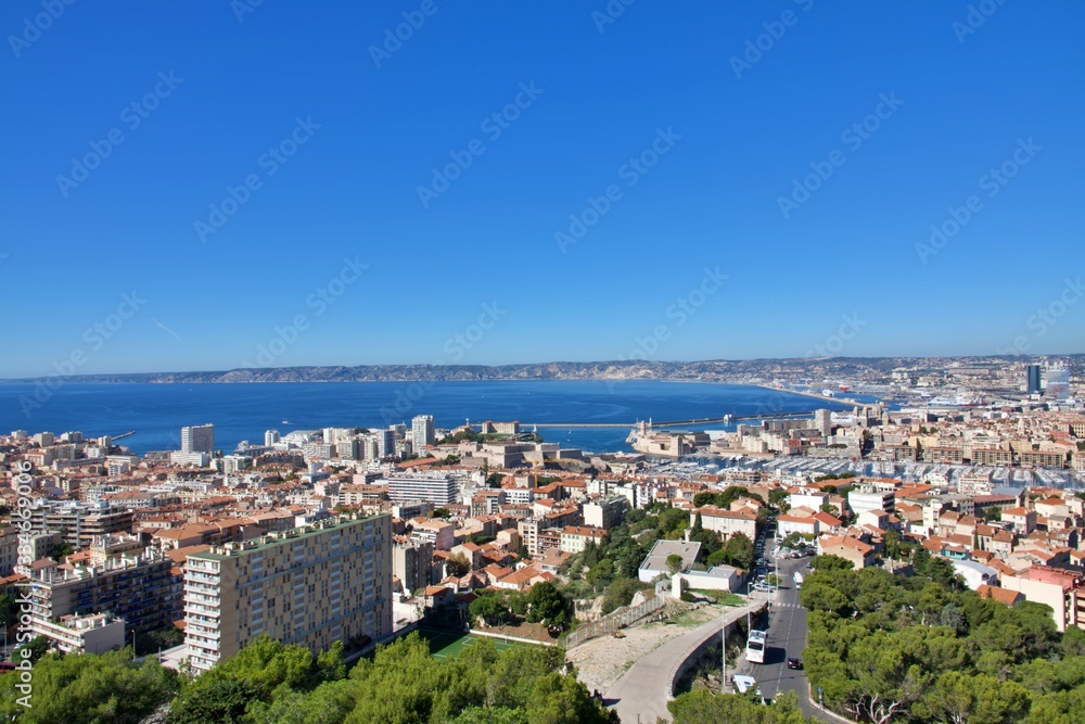 Aerial panoramic view of beautiful Marseille, France under blue sky; blue sky and city