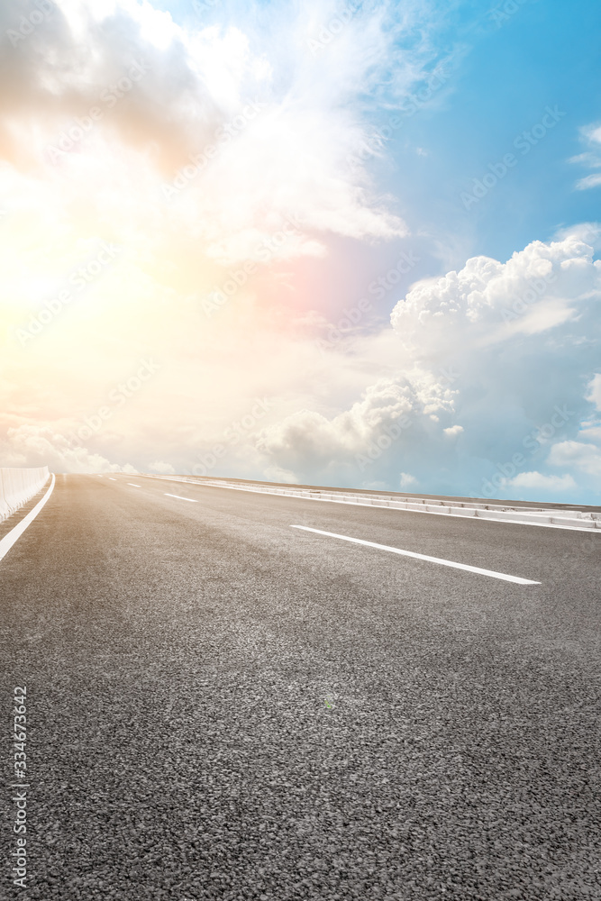 Asphalt highway road and sky sunset clouds landscape.