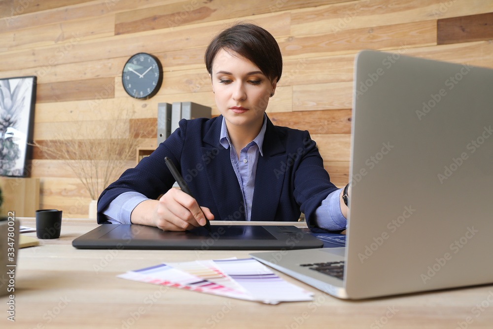 Young female designer working in office