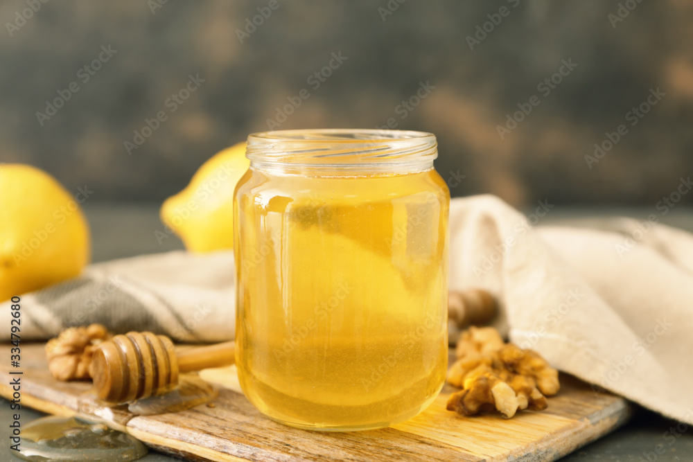 Jar of sweet honey on table